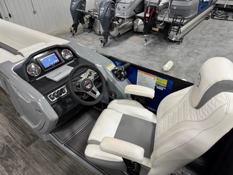 Slide: The Image of Captain's seat and dashboard of 2020 Godfrey 250 Monaco boat, featuring modern controls and steering. - 7