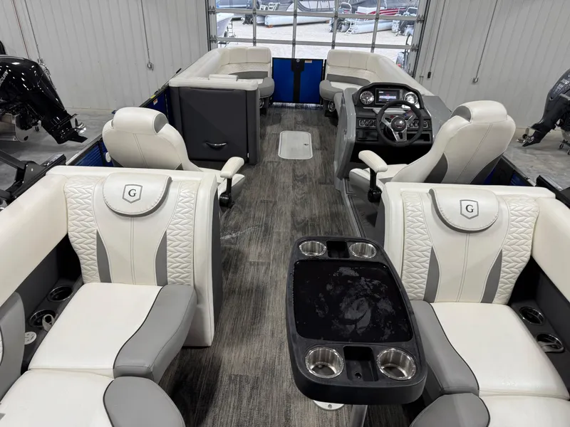 Slide: The Image of 2020 Godfrey 250 Monaco pontoon boat interior with luxurious seating and modern dashboard. - 8