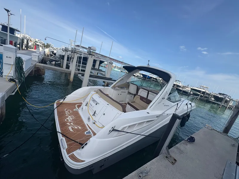 The Image of 2008 Sea Ray 330 Sundancer docked at marina under clear blue sky. - 0