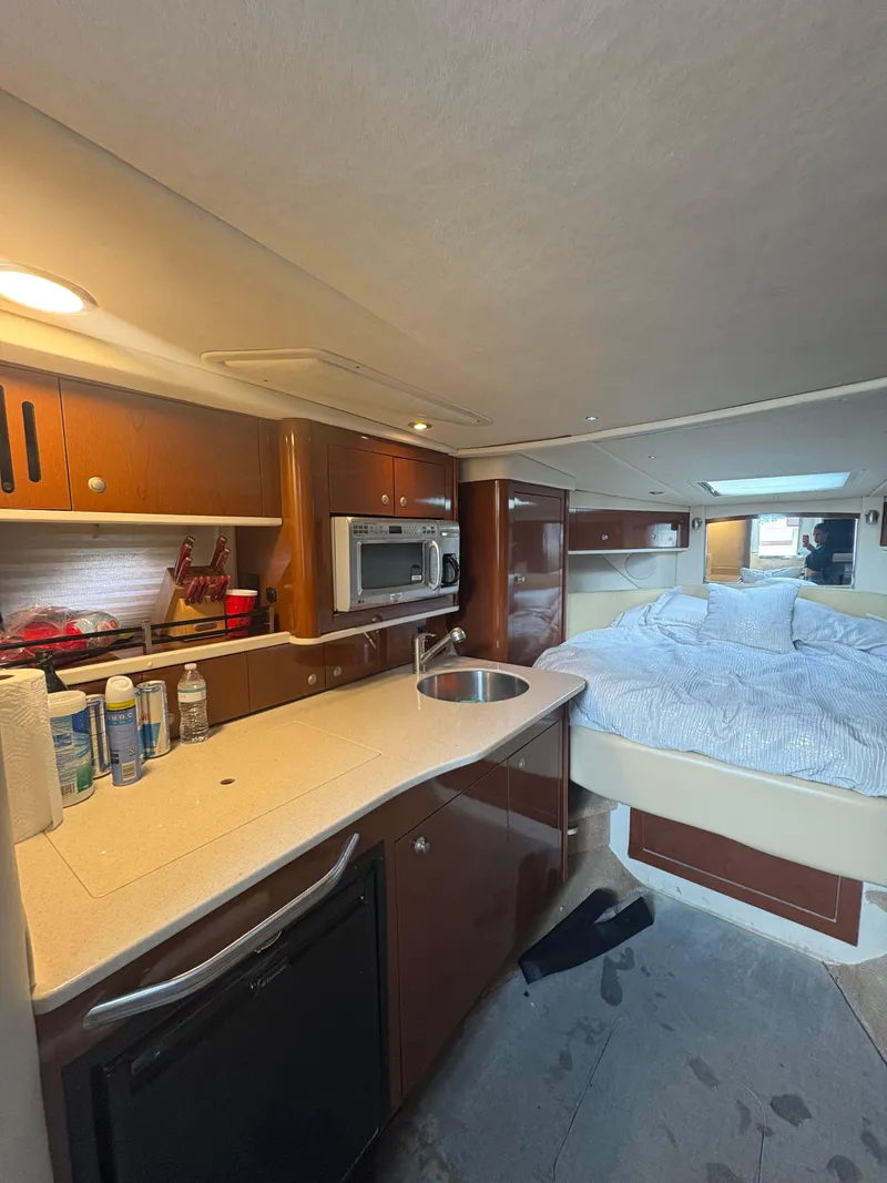 Slide: The Image of Interior of 2008 Sea Ray 330 Sundancer with kitchenette and cozy sleeping area. - 16