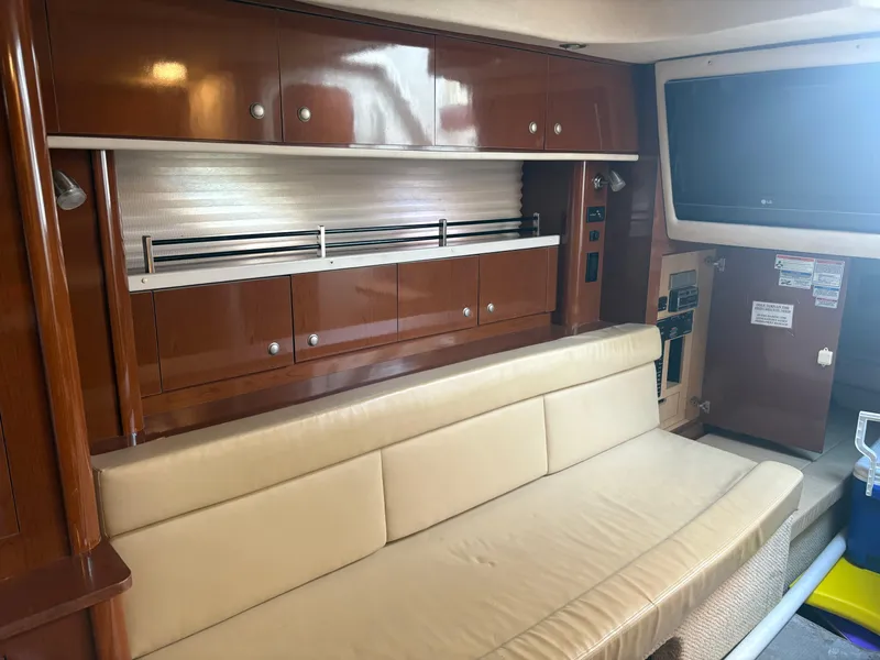 Slide: The Image of Interior of 2008 Sea Ray 330 Sundancer with beige seating and wooden cabinetry. - 17