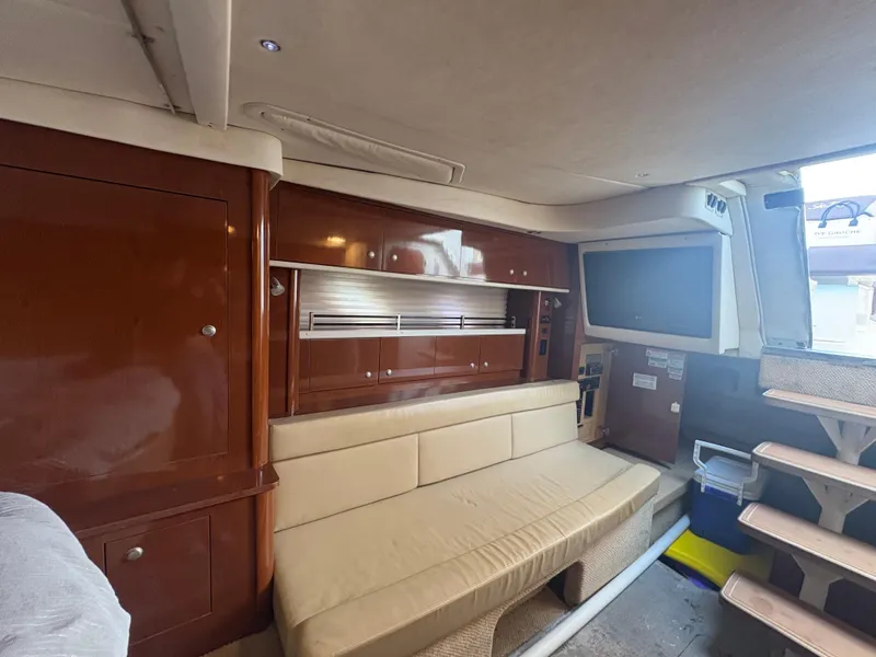 Slide: The Image of Interior of 2008 Sea Ray 330 Sundancer with beige seating and wooden cabinetry. - 18
