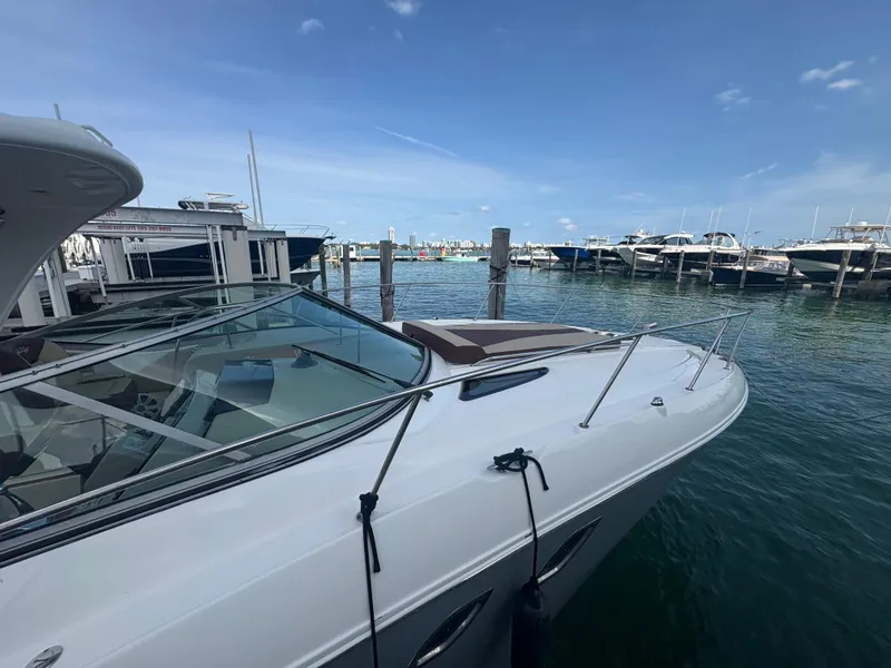 Slide: The Image of 2008 Sea Ray 330 Sundancer docked at marina, clear sky, calm water. - 2