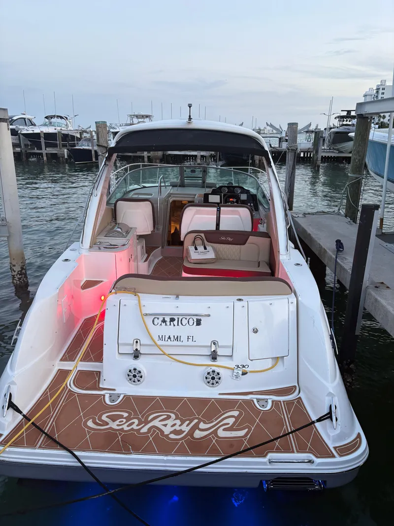 Slide: The Image of 2008 Sea Ray 330 Sundancer docked, featuring spacious deck and elegant interior. - 5