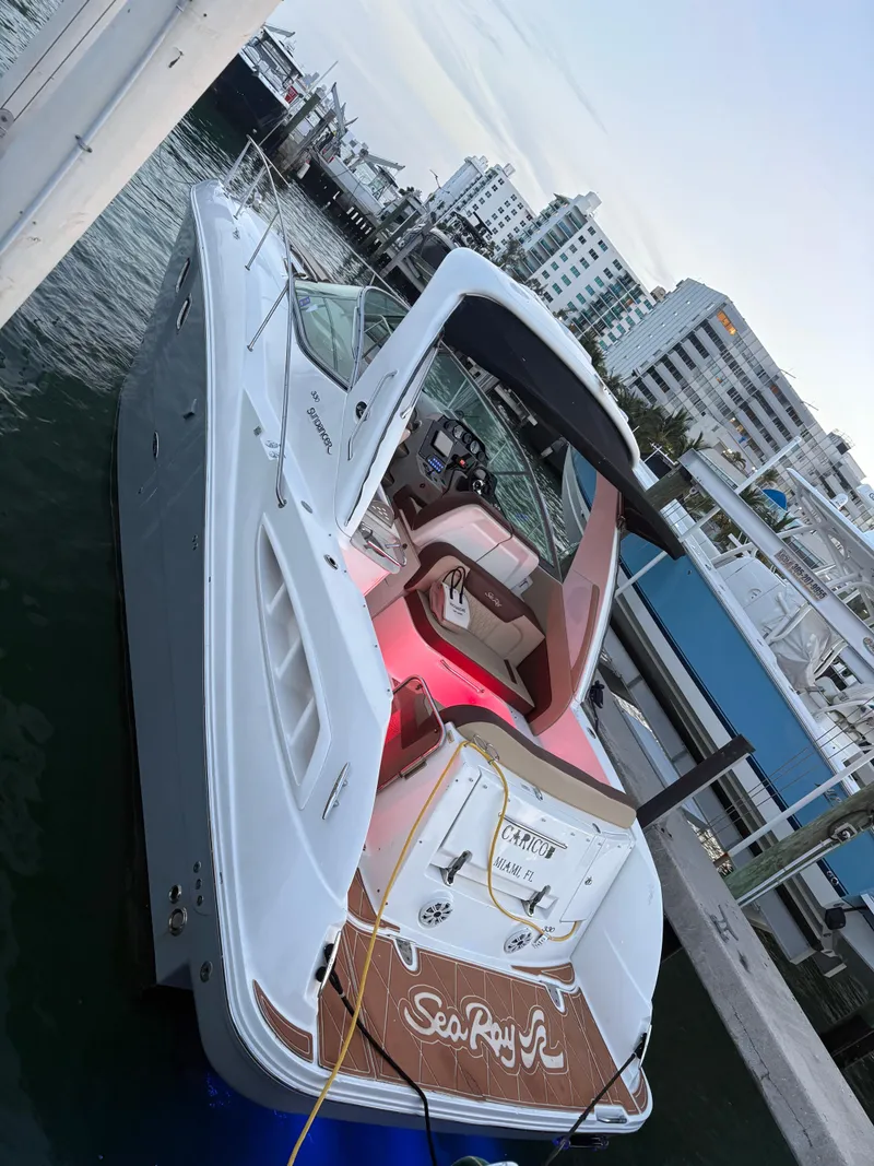 Slide: The Image of 2008 Sea Ray 330 Sundancer docked at marina, showcasing sleek design and spacious deck. - 7