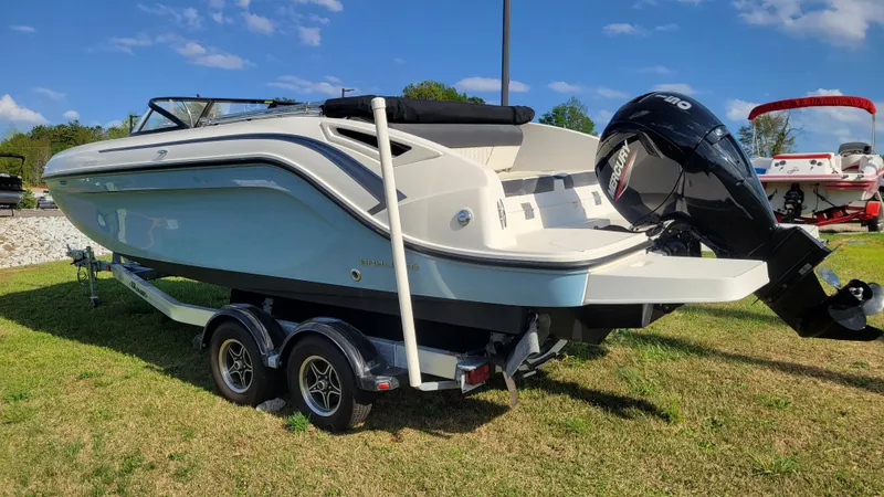 Slide: The Image of 2021 Bayliner DX 2200 boat on trailer, featuring a Mercury outboard motor. - 5