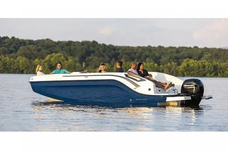 Slide: The Image of 2021 Bayliner DX 2200 boat cruising on a lake with passengers onboard. - 9