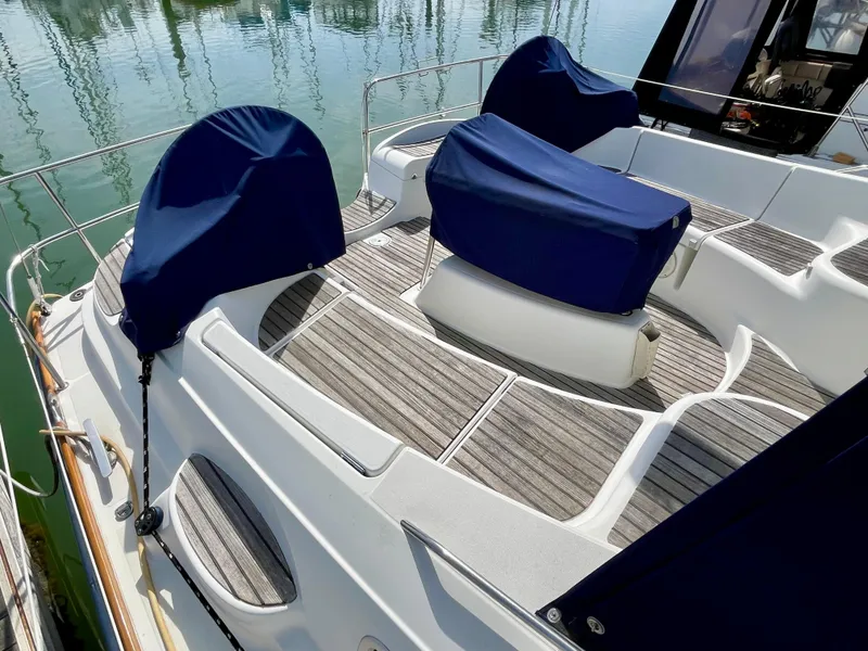 Slide: The Image of 2008 Jeanneau Sun Odyssey 42 DS yacht deck with blue covers and wooden flooring. - 10