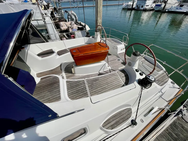 Slide: The Image of 2008 Jeanneau Sun Odyssey 42 DS sailboat with wooden deck and steering wheel in marina. - 11