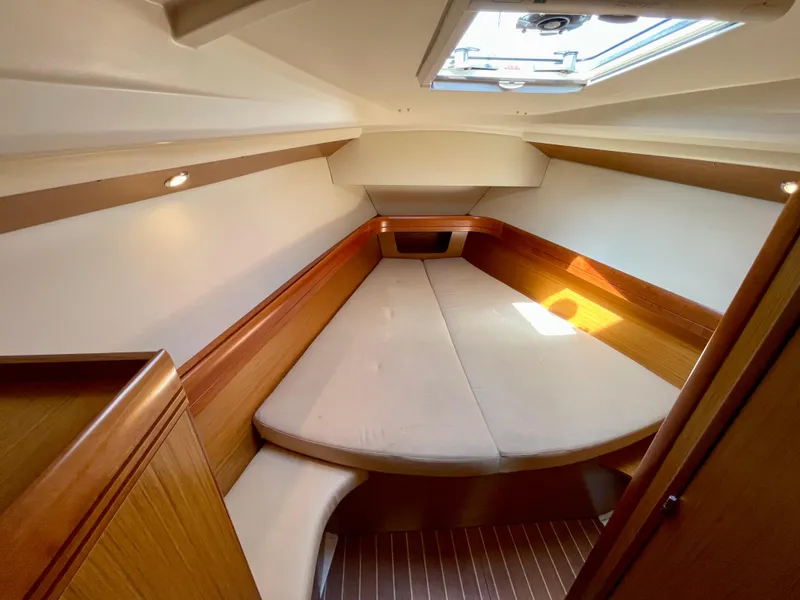 Slide: The Image of 2008 Jeanneau Sun Odyssey 42 DS cabin interior with cozy bed and natural lighting. - 18