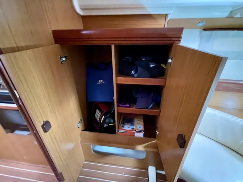Slide: The Image of Cabinet storage inside 2008 Jeanneau Sun Odyssey 42 DS sailboat, featuring organized shelves and items. - 24