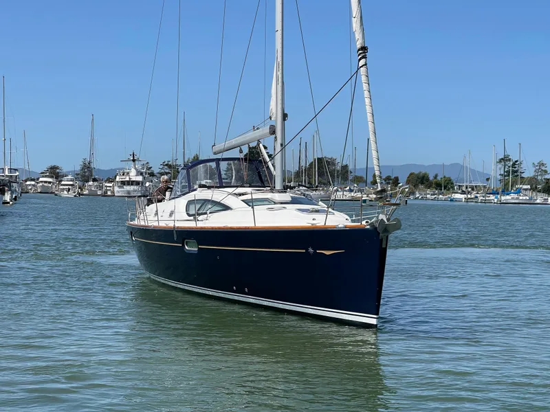 Slide: The Image of 2008 Jeanneau Sun Odyssey 42 DS sailboat on calm water, marina background. - 3