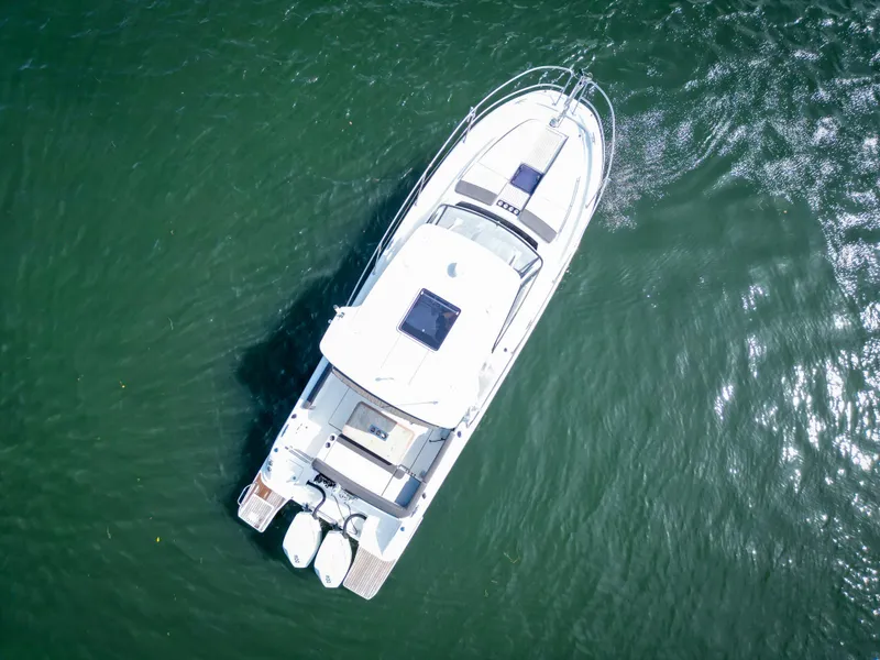 Slide: The Image of Aerial view of 2021 Jeanneau Leader 10.5 WA boat on water. - 11