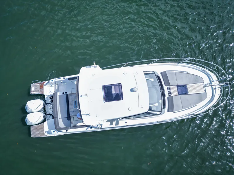 Slide: The Image of Aerial view of 2021 Jeanneau Leader 10.5 WA boat on water. - 12
