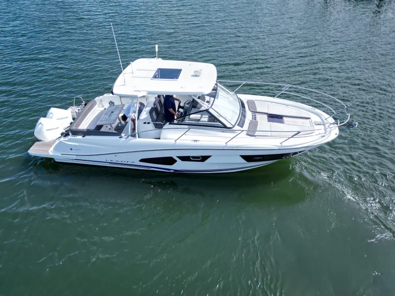Slide: The Image of 2021 Jeanneau Leader 10.5 WA boat cruising on calm water. - 13
