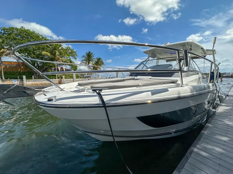 Slide: The Image of 2021 Jeanneau Leader 10.5 WA boat docked, sunny day, clear skies, palm trees in background. - 15
