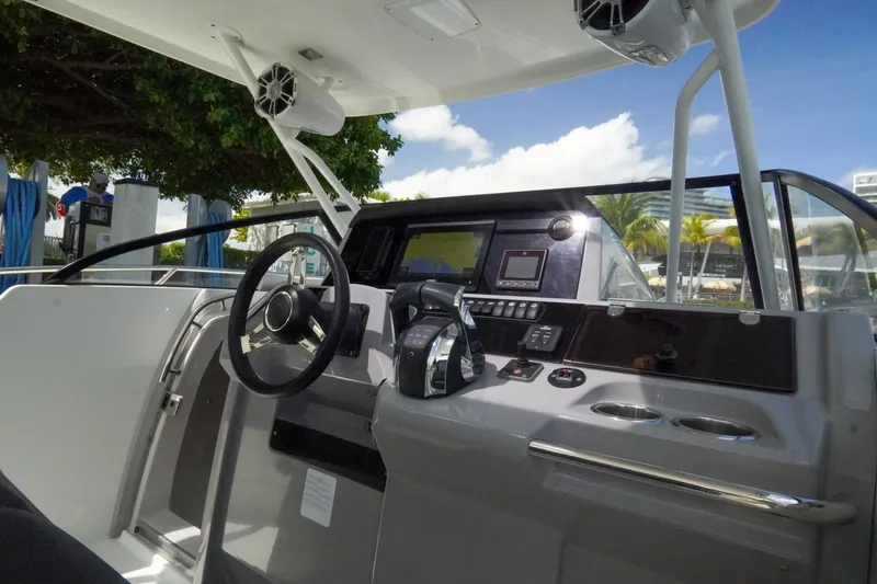 Slide: The Image of 2021 Jeanneau Leader 10.5 WA boat cockpit with modern controls and steering wheel. - 19