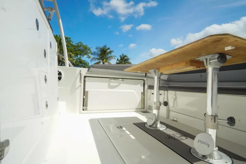 Slide: The Image of 2021 Jeanneau Leader 10.5 WA boat interior with table, tropical backdrop. - 27