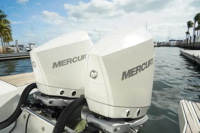 Slide: The Image of Twin Mercury outboard engines on a 2021 Jeanneau Leader 10.5 WA boat at a marina. - 30