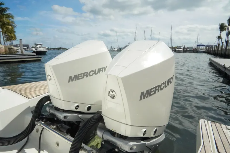 Slide: The Image of Twin Mercury outboard engines on a 2021 Jeanneau Leader 10.5 WA boat at a marina. - 31