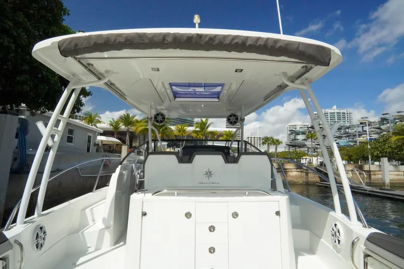 Slide: The Image of 2021 Jeanneau Leader 10.5 WA boat docked, showcasing spacious deck and modern design. - 33