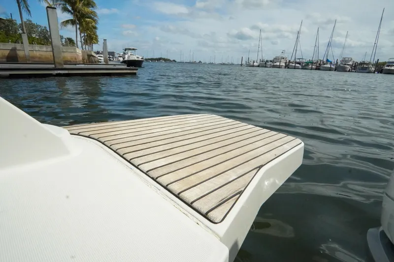 Slide: The Image of 2021 Jeanneau Leader 10.5 WA swim platform on calm marina waters. - 34