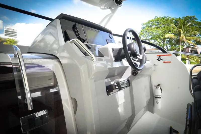Slide: The Image of 2021 Jeanneau Leader 10.5 WA boat cockpit with steering wheel and control panel. - 36