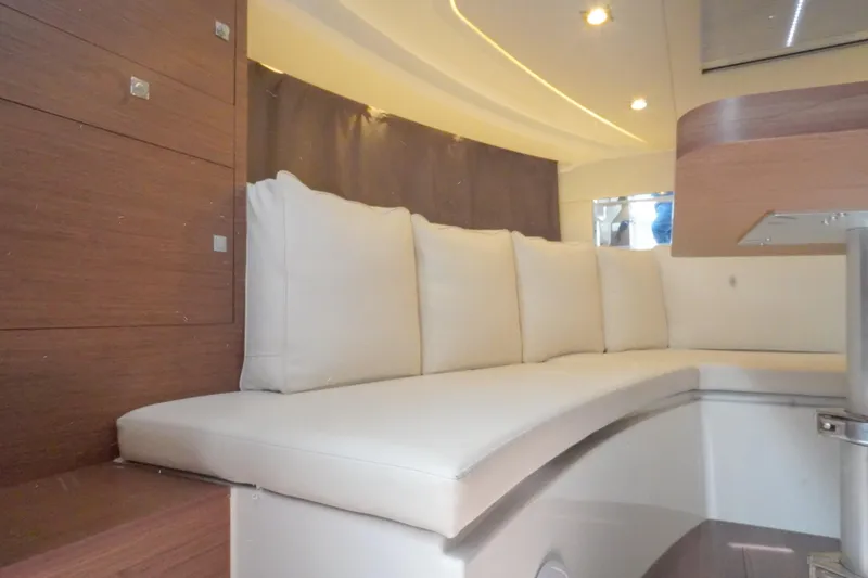 Slide: The Image of Interior of 2021 Jeanneau Leader 10.5 WA with white cushioned seating. - 38