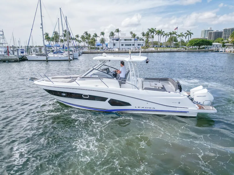 Slide: The Image of 2021 Jeanneau Leader 10.5 WA boat cruising in a marina with palm trees. - 4