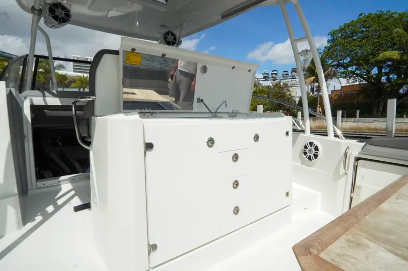 Slide: The Image of 2021 Jeanneau Leader 10.5 WA boat interior with seating and storage compartments. - 44
