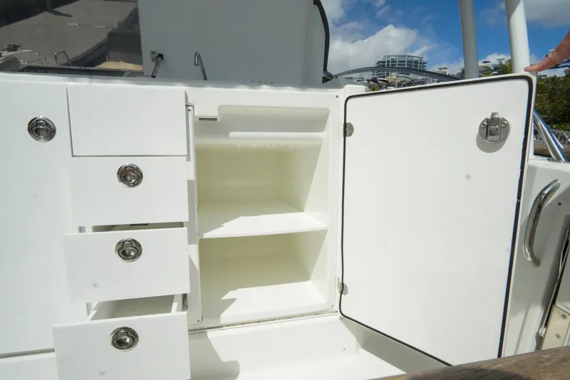 Slide: The Image of 2021 Jeanneau Leader 10.5 WA boat storage compartments with open shelves and drawers. - 48