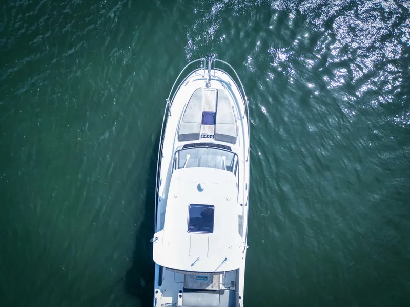 Slide: The Image of Aerial view of 2021 Jeanneau Leader 10.5 WA boat on water. - 5