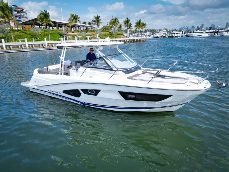 Slide: The Image of 2021 Jeanneau Leader 10.5 WA boat cruising in a scenic marina setting. - 6