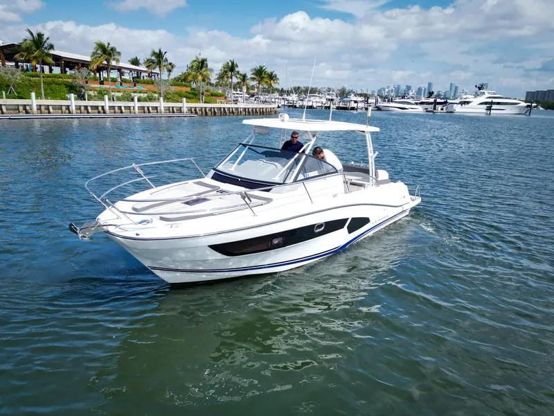 Slide: The Image of 2021 Jeanneau Leader 10.5 WA cruising in a scenic marina setting. - 8