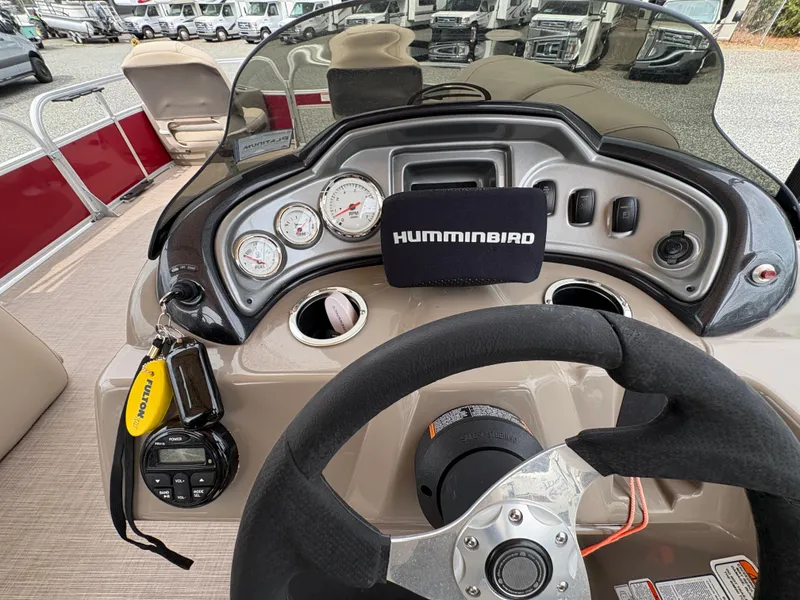 Slide: The Image of 2021 Sun Tracker Fishin' Barge 20 DLX dashboard with Humminbird electronics and gauges. - 13