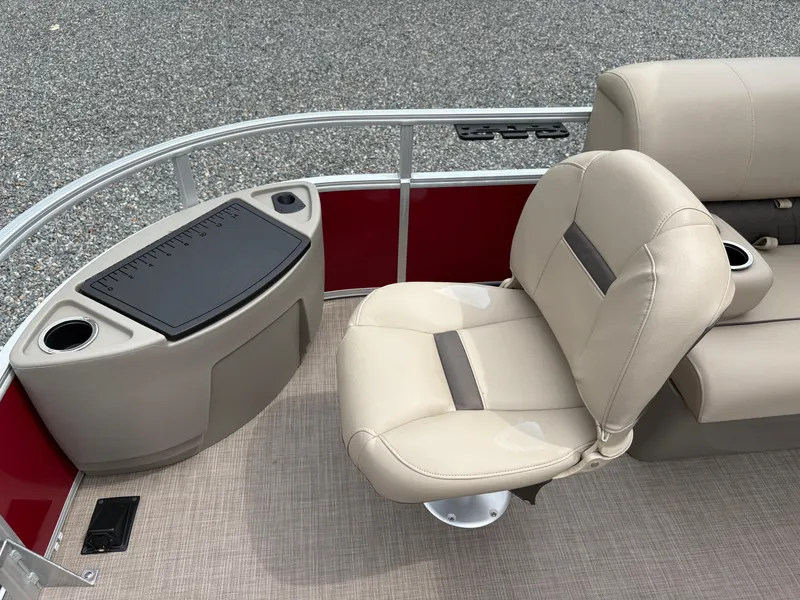 Slide: The Image of 2021 Sun Tracker Fishin' Barge 20 DLX interior with beige seating and fishing station. - 17