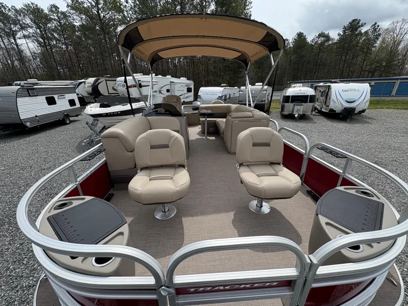 Slide: The Image of 2021 Sun Tracker Fishin' Barge 20 DLX pontoon boat with beige seating and canopy. - 18