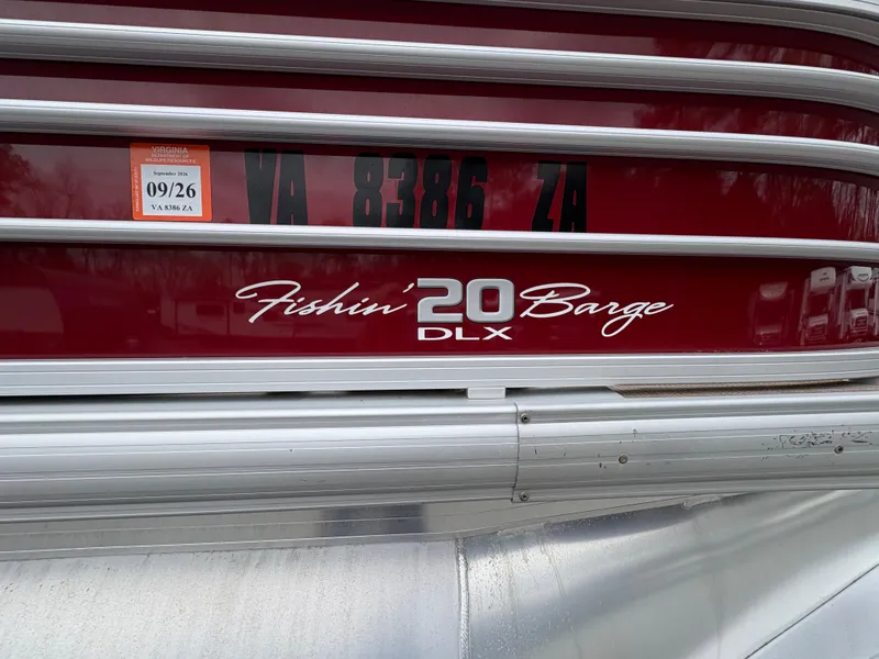 Slide: The Image of 2021 Sun Tracker Fishin' Barge 20 DLX, red and silver exterior with registration sticker. - 19