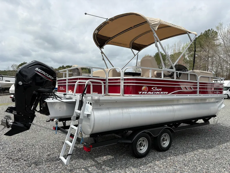 Slide: The Image of 2021 Sun Tracker Fishin' Barge 20 DLX pontoon boat with canopy and Mercury outboard motor. - 5