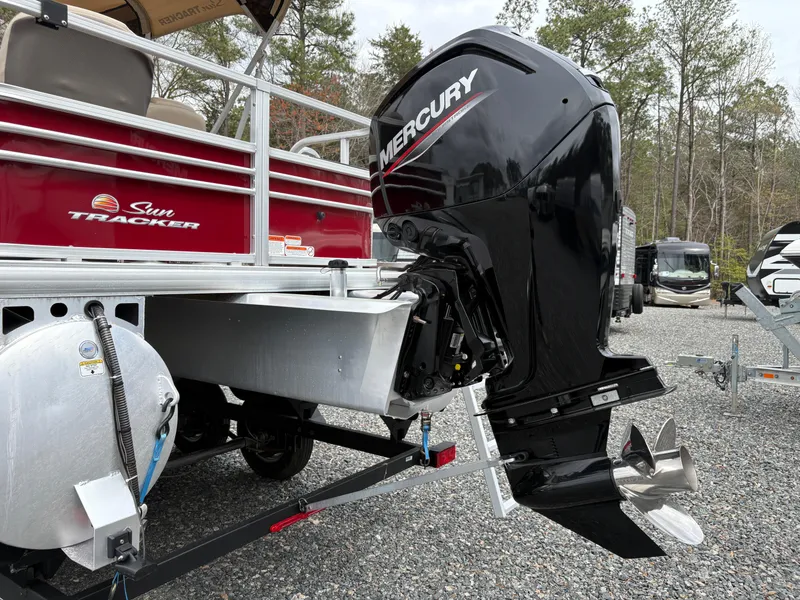 Slide: The Image of 2021 Sun Tracker Fishin' Barge 20 DLX with Mercury outboard motor, parked on gravel. - 8