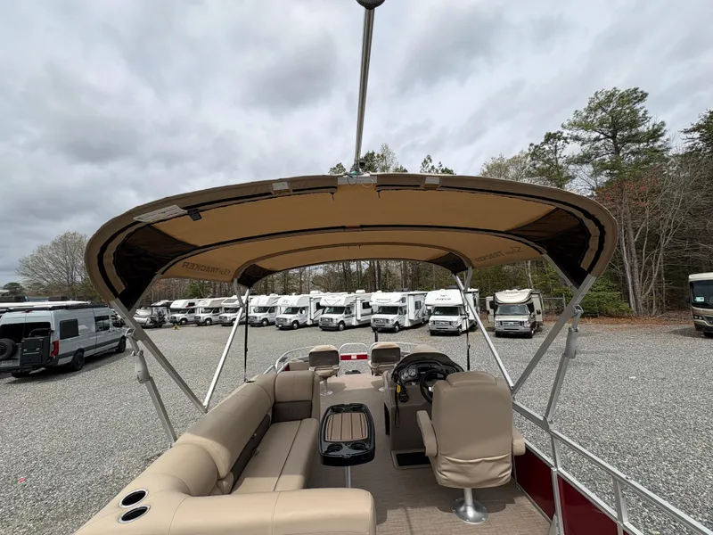 Slide: The Image of 2021 Sun Tracker Fishin' Barge 20 DLX pontoon boat with canopy, parked in a lot. - 9
