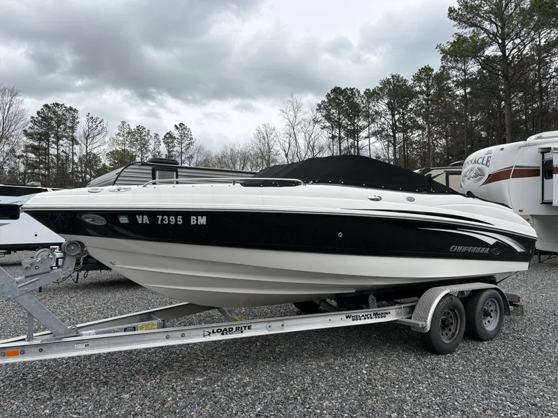 Slide: The Image of 2009 Chaparral 210 SSi boat on trailer, parked outdoors under cloudy sky. - 0