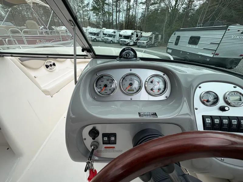 Slide: The Image of 2009 Chaparral 210 SSi boat dashboard with gauges and steering wheel. - 10