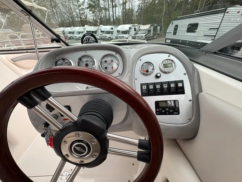 Slide: The Image of 2009 Chaparral 210 SSi boat dashboard with steering wheel and instrument panel. - 11