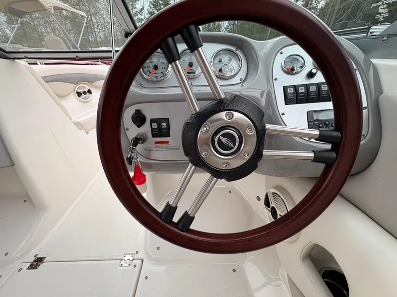 Slide: The Image of Steering wheel and dashboard of 2009 Chaparral 210 SSi boat interior. - 12