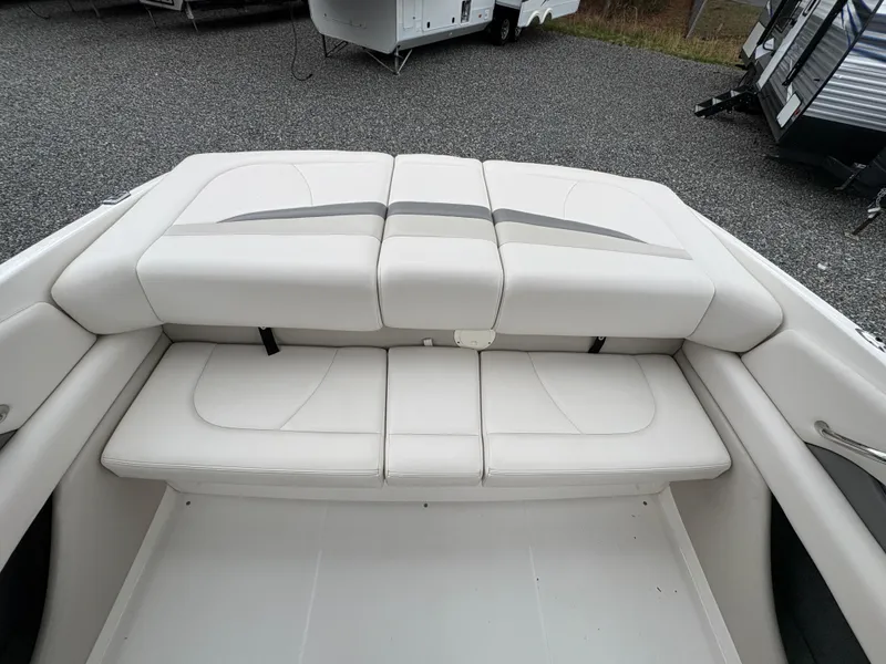 Slide: The Image of 2009 Chaparral 210 SSi boat interior with white cushioned seating. - 15