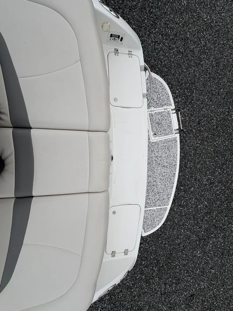 Slide: The Image of 2009 Chaparral 210 SSi boat interior with cushioned seating and swim platform. - 16