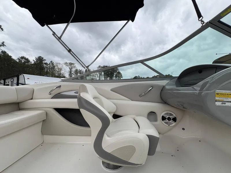 Slide: The Image of 2009 Chaparral 210 SSi boat interior with white seating and steering console. - 18
