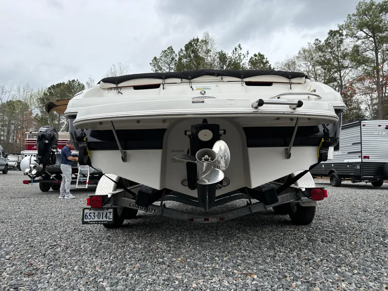 Slide: The Image of Rear view of a 2009 Chaparral 210 SSi boat on a trailer in a parking area. - 2