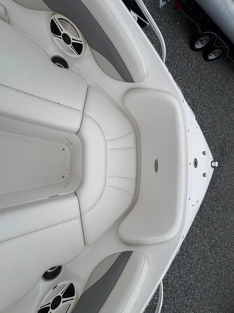 Slide: The Image of 2009 Chaparral 210 SSi boat interior with white seating and speaker details. - 20